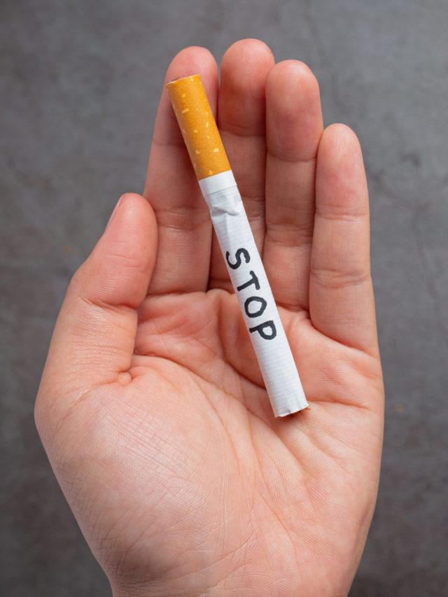 human_hand_holding_cigarette_world_no_tobacco_day_concept_42d77f41a6