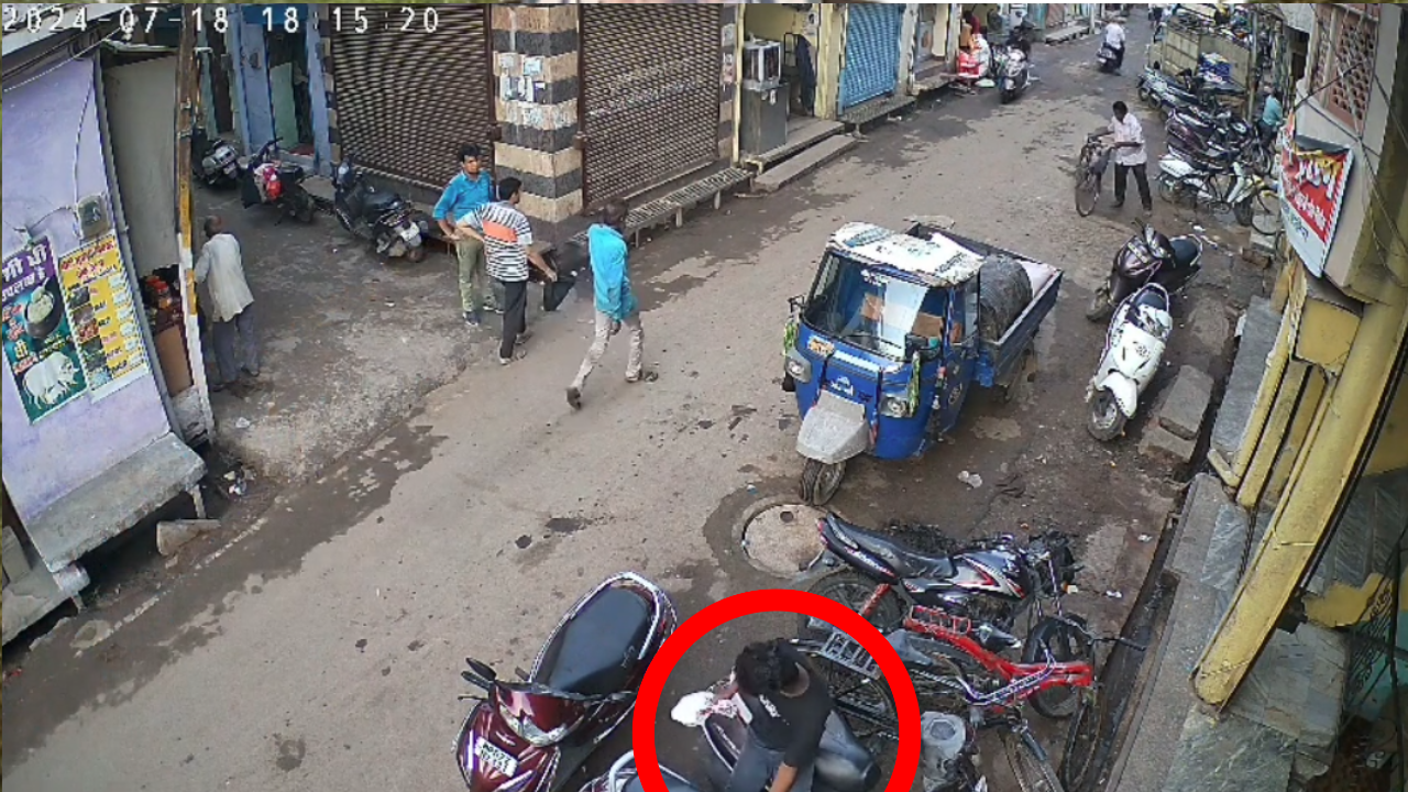 young man was seen taking out polythene filled with money from the trunk of the Activa.