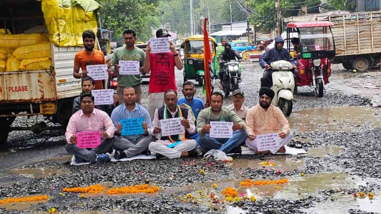 Congressmen protesting in a road full of potholes