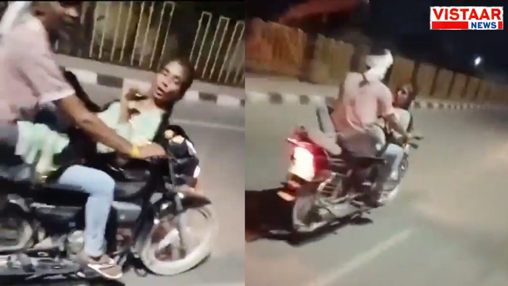 Stunt by a young man and woman on a moving bike in Firozabad, UP.