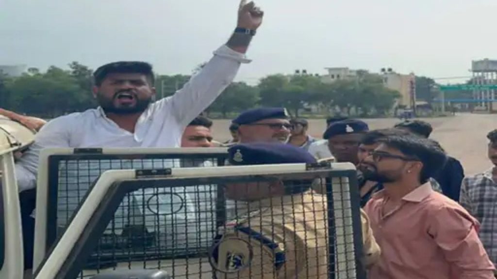 Police taking Chhattisgarh Youth Congress leader Bhavesh Shukla into custody.