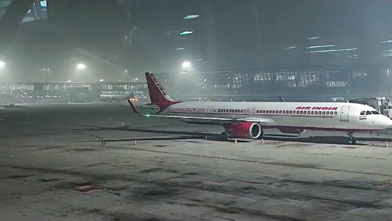 Delhi IGI Airport flight information display showing delays due to ATC technical glitch