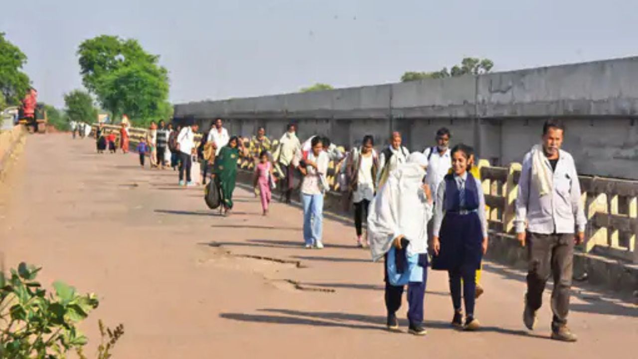People walking next to the bridge built at a cost of Rs 21 crore.