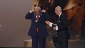 Donald Trump receiving FIFA peace award and wearing medal himself