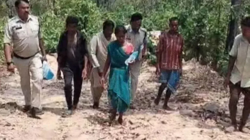 Police personnel escorting the accused mother to the crime scene.