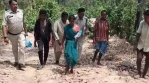 Police personnel escorting the accused mother to the crime scene.