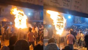 Fire flares up in young man's mouth while performing a fire stunt.