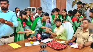धनबाद में छात्राओं से राखी बंधवाते अध‍िकारी